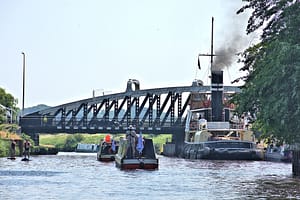 The FBW flotilla passing the Daniel Adamson on the River Weaver